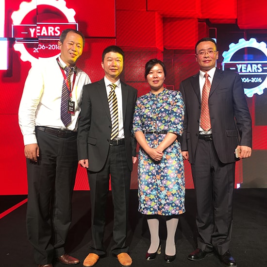 China wins ‘Top Business Partner Award’ from GETRAG. One woman and three men accepting an award