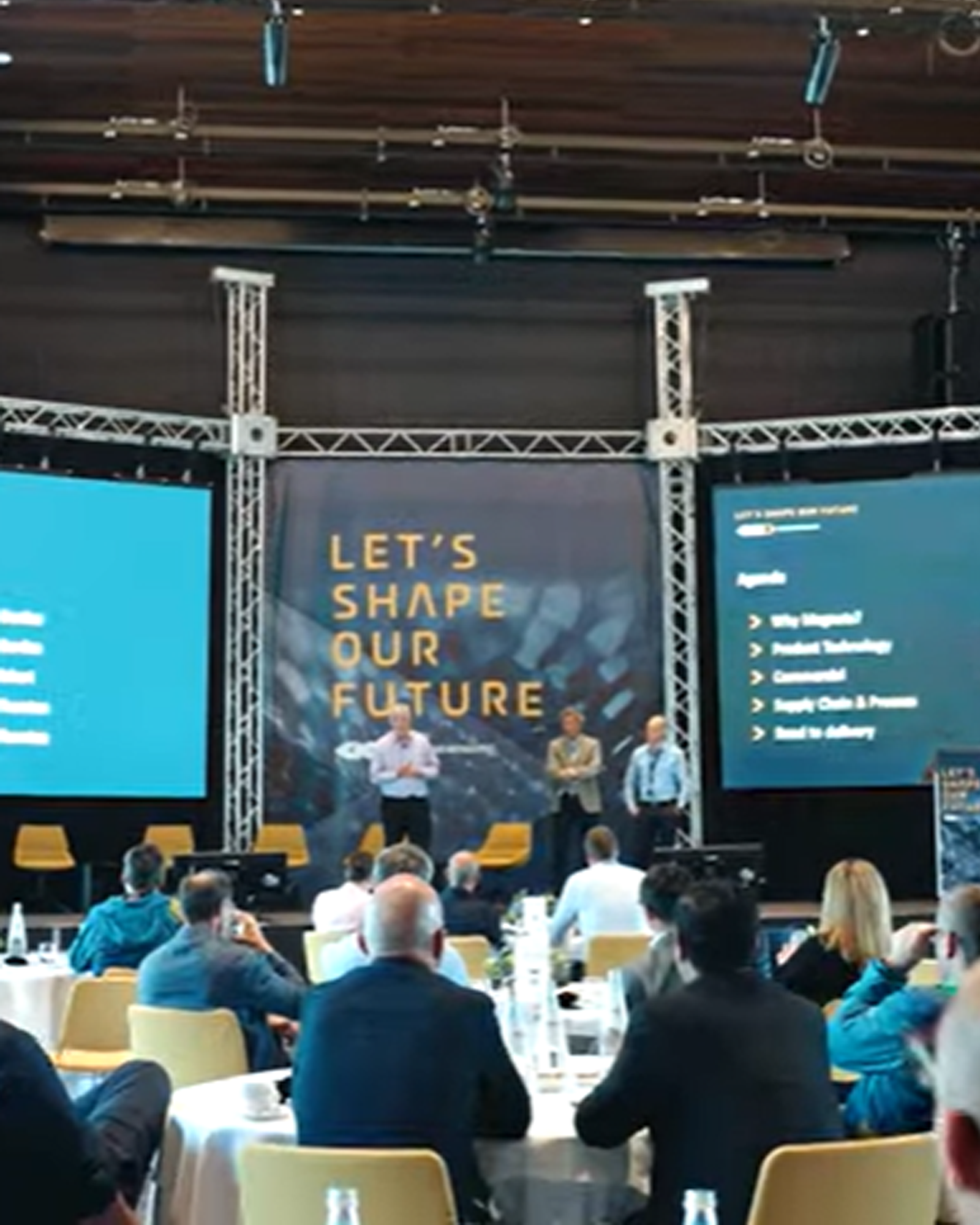 Speakers on stage at an event