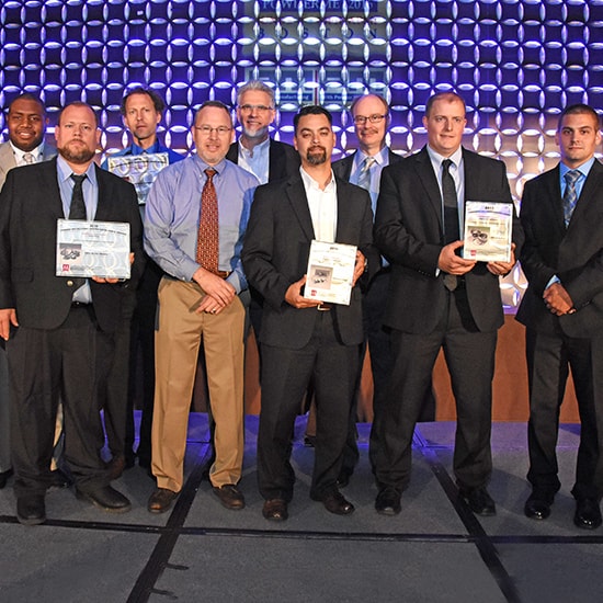 GKN awarded for design excellence by MPIF. Nine men standing on a stage accepting awards