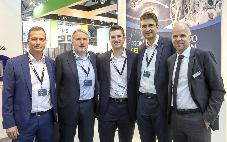 Five men in suits at an event