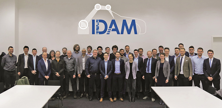 Idam team photo in a meeting room